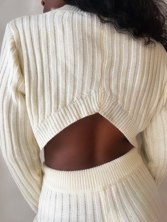 model wearing vanilla ribbed knit crop open back sweater