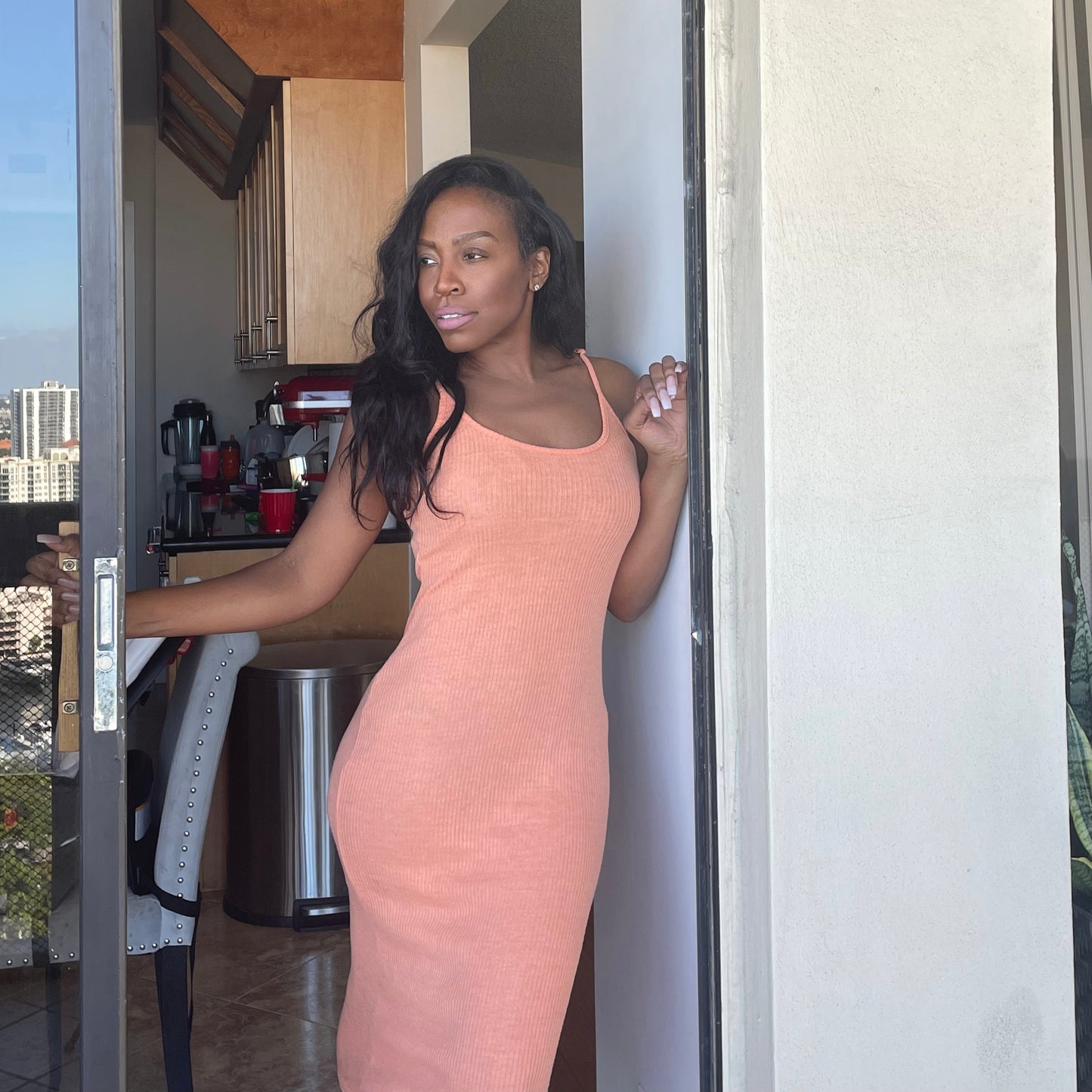 Model wearing knit slip dress in tangerine orange