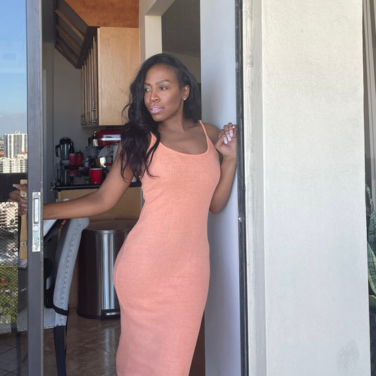 Model wearing knit slip dress in tangerine orange