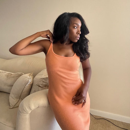 Model wearing knit slip dress in tangerine orange