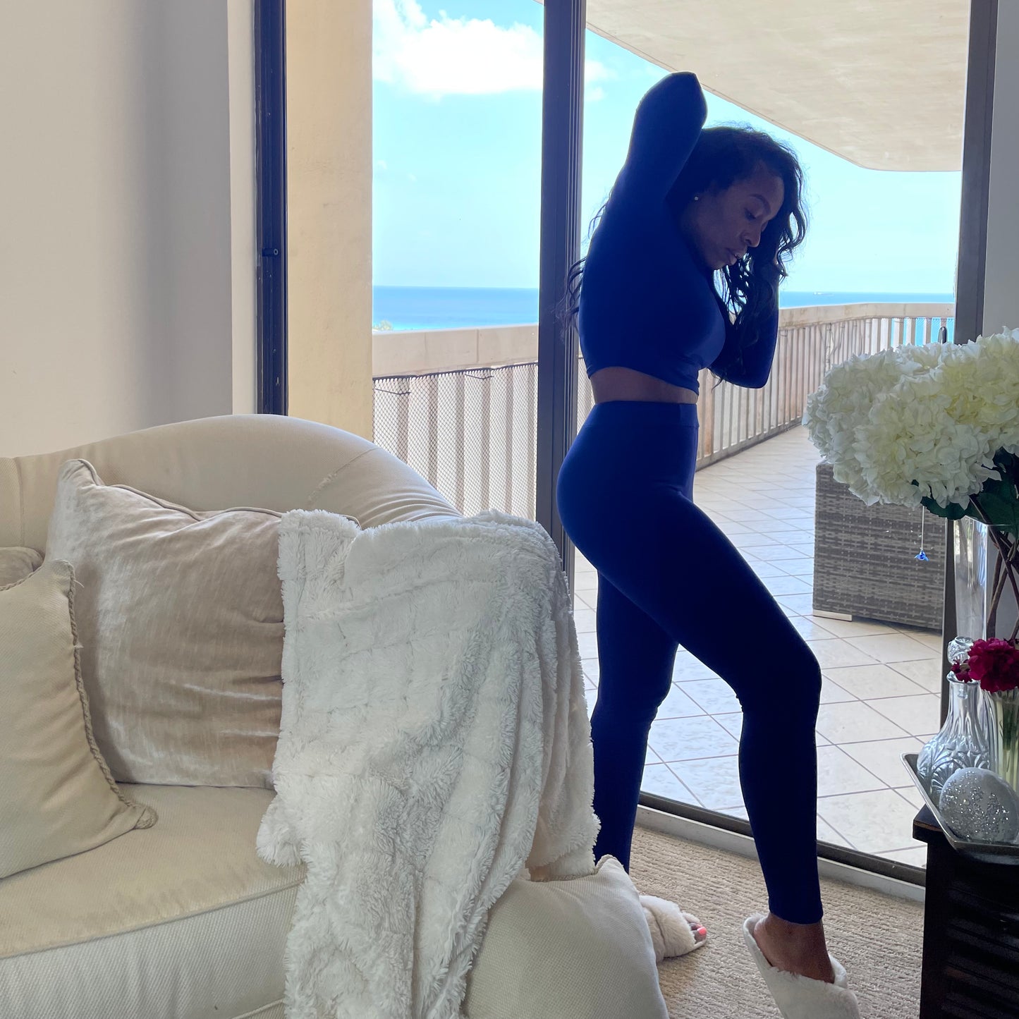 Model near window wearing High Waisted Leggings for Women Front Side Deep Blue