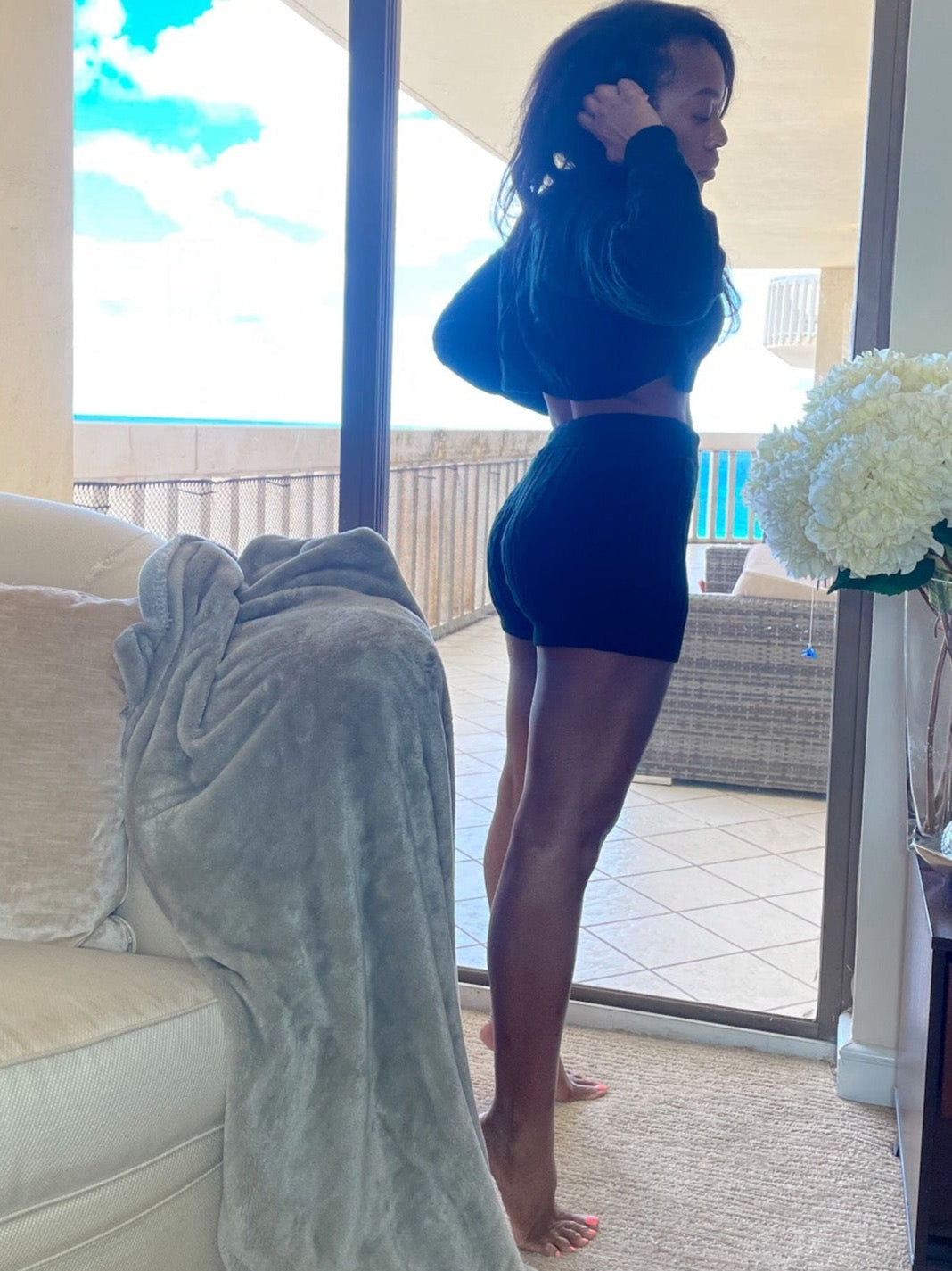 Model standing near ocean view wearing Cable Knit BoyShorts knitted co ord, lounging shorts, women's lounge shorts in black