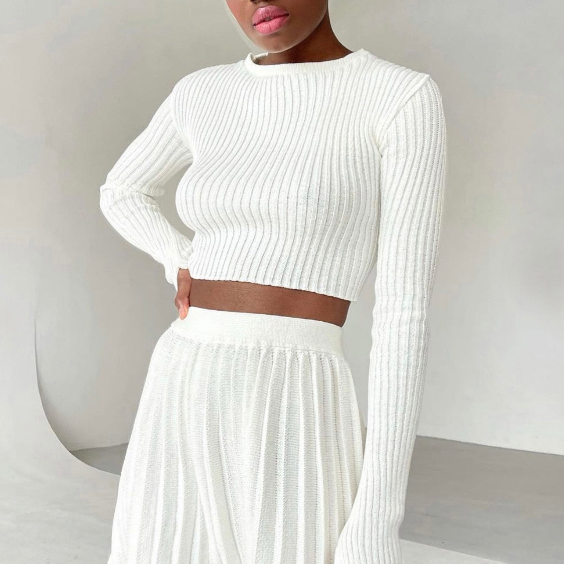 Model wearing Ribbed Knit Long Sleeve Crop Top white knit skirt and top set